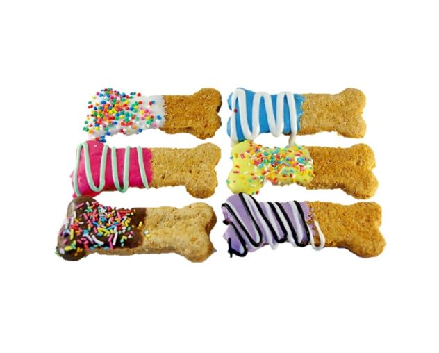 Colorful bone-shaped dog treats with various toppings. Australian Made Natural and Hand Decorated Dog Treats